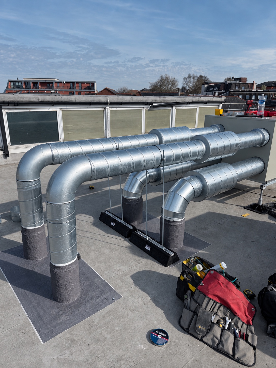 ADCON rooftop ventilation installation with galvanised ductwork connected to a ventilation unit